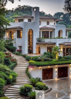 a large white house surrounded by greenery and trees