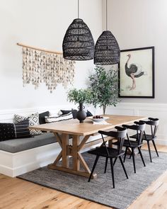 a dining room table with four chairs and a bench in front of it, hanging from the ceiling