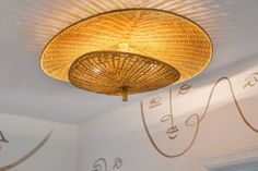 the ceiling light is made out of wicker and has an intricate design on it