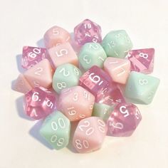 a pile of pastel colored dices with numbers on them