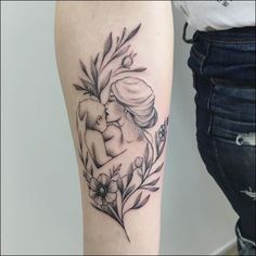 a woman's arm with a tattoo on it that has flowers and an elephant