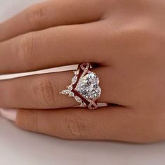 a woman's hand with a ring on it and a diamond in the middle