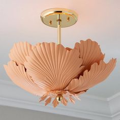 a chandelier hanging from the ceiling in a room with white walls and ceilings