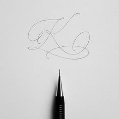 the word love is written in cursive writing on a white paper with a black pen