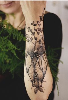 a woman is holding her arm with flowers on it