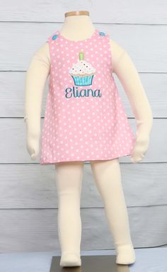 "This little cup cake dress is a must have for a first birthday outfit for girl. If it is for 1st birthday or 2nd birthday girl, she will look sweet in this baby girl jumper dress. First birthday dress is pink polka dot and can come plain, with cupcake applique or with applique and monogram. Zuli Kids Premium Quality *100% Cotton Outer - Fully Lined *Machine Wash Gentle *1st Birthday Outfits *Shoulder Button Closures *Available in Size 3 Mo - Size 5 *Special Classic Garment to Commemorate the Sp Cute Cotton Birthday Dress, Cute Cotton Dress For Birthday, Cute Ruffled Dress For Birthday, Sweet White Dress For Birthday, Sweet White Birthday Dress, Sweet Sleeveless Dress For First Birthday, Cute Sleeveless Dress For Birthday, Cotton Sleeveless Birthday Dress, Cute Pink Dress For Cake Smash