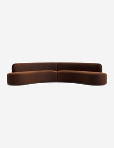 the curved sofa is made from dark brown fabric and has a long armrest that extends to