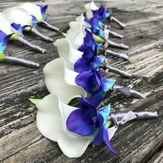 blue and white flowers are arranged on a wooden table