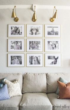 a living room with pictures hanging on the wall and pillows sitting on the couch in front of it