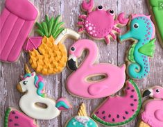 decorated cookies are arranged in the shape of flamingos, seahorses and dolphins