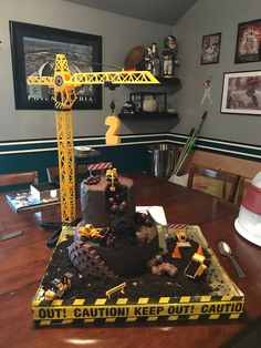 a construction themed cake sits on a table