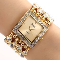 Description: Look great, feel wonderful and sophisticated, wearing this luxuriously beautiful, stylish, and gorgeous gold tone and silver tone rectangular square dial bracelet watch. With this selection of watches, you can always add a splash of elegant bracelet and classy style to your collection of watches! This is an excellent choice of stylish bracelet watch that comes with the gold and silver tones to choose from, and it is fantastic as a gift for yourself or for your loved ones to wear and Elegant Watches Women, Pretty Watches, Bracelet Watches Women, Expensive Watches, Fairy Figurines, Big Diamond, Earrings Design, Fossil Watches, Stylish Bracelet