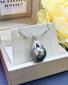 "Jewelry is the one thing that has the power to make you feel absolutely unique and elegant. Dazzle yourself and everyone around you with this cute and lustrous Tahiti, South Sea Pearl pendant. Featuring a RARE, LUSTROUS 14 mm Natural, Round, White South Sea Pearl, accented by 35 pieces of Brilliant Round diamonds weighing at 0.40 carat. Set in 18K solid white gold, handcrafted by professional goldsmith. All gems have been selected and graded for their unsurpassed quality and authenticity. ONE O Elegant Tahitian Pearl Drop Necklace, Luxury Tahitian Pearl Necklace In White Gold, Tahitian Pearl Round Pendant Necklace For Anniversary, Silver Tahitian Pearl Necklace Fine Jewelry, Silver Tahitian Pearl Necklace, Elegant Silver Tahitian Pearl Necklace, Tahitian Pearl Pendant Necklaces For Formal Occasions, Luxury Tahitian Pearl Pendant Necklace, Gray Pearl Pendant Jewelry As Gift