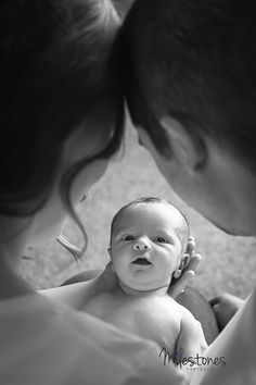 a man holding a baby in his arms