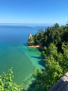 the water is very clear and blue in this area with trees on either side of it