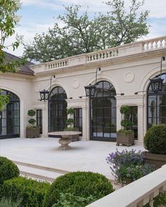 an outdoor courtyard with potted plants and trees