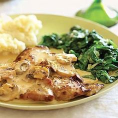 a plate with meat, mashed potatoes and spinach