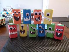 some very cute little boxes that have monster faces on them and are sitting on a table