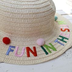 A beautiful child's sun hat to match mummy on holiday. The hat is a straw style with Fun In The Sun embroidered on the one side of the rim and your Child's Initials Embroidered on the other side. In matching red and pink thread from the fun in the sun phrase. The hat features beautiful coloured text and 3 stuck on pompoms in various colours.The ideal summer accessory for those little ones on the beach enjoying the sunshine in the summer holidays. The hats are size 7 - 10 years and we have limite Playful Spring Hats For Play, Fun Spring Hats For Play, Fun Spring Play Hats, Playful Brimmed Sun Hat For Play, Playful Brimmed Sun Hat, Summer Play Brimmed Bucket Hat, Summer Play Cap Hat, Summer Brimmed Bucket Hat For Play, Summer Play Cap