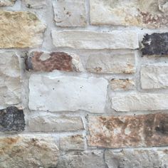 an old brick wall is shown with brown and white bricks