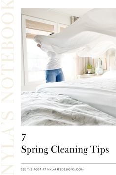 a woman standing on top of a bed with the words 7 spring cleaning tips in front of her