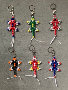 six key chains made out of legos are arranged in the shape of an individual figure