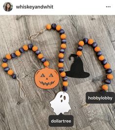 a wooden bead necklace with halloween decorations on it