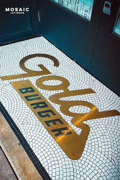 the entrance to a building with a sign that says booze on it's floor