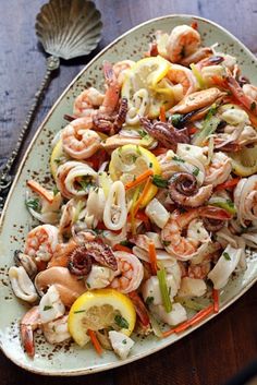 a plate filled with pasta and shrimp on top of a table