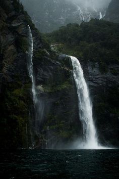 there is a waterfall in the middle of the water and it looks like it's falling