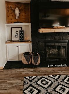 a living room with a fireplace, television and rug