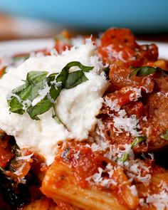 pasta with meat, sauce and parmesan cheese on top