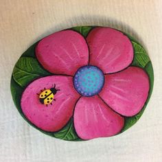 a painted flower with a ladybug on it