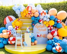 an outdoor birthday party with balloons and decorations