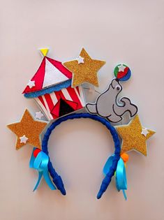 a close up of a headband with an elephant on it and stars in the background