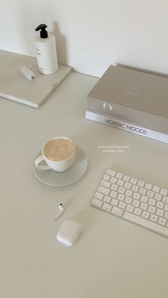 a laptop computer sitting on top of a desk next to a cup of coffee and mouse