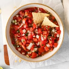 a bowl filled with salsa and tortilla chips