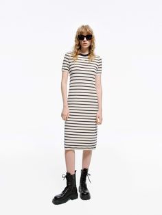 MO&Co. Women's Round Neck Striped Dress Crafted with a blend of wool and fabric, this mid-length T-shirt dress boasts a modern silhouette and stylish striped design. Perfectly pair with short boots for a minimalist, fashion-forward look. Features : - Midi T-shirt dress silhouette- Classic black and white stripes- Round neck, short sleeves Code: MBD1DRS038The back length of size S is 104cmMATERIALS & CARE Material: 67.7% Wool 32.3% PolyesterWrap metal parts before dry cleaning.REMINDER: All items Contrast Stripe Dresses For Workwear, Striped Hem Dress For Work, Fall Striped Knee-length Midi Dress, Spring Workwear Dresses With Contrast Stripes, Striped Midi Dress For Work, Spring Fitted Dresses With Contrast Stripes, Striped Knee-length Midi Dress For Work, Fitted Spring Dresses With Contrast Stripes, Fitted Dress With Contrast Stripes For Spring