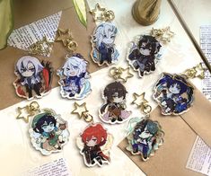 six anime key chains sitting on top of a table