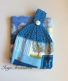 a crocheted blue bag with a tree on it