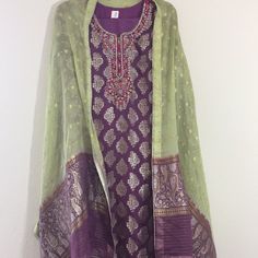 Elegant Purple And Green Jamawar Embroidered Dress-3 Pcs- Shirt Is Jamawar With Gold Embroidery Of Dabka And Stones-Long Sleeves- Scarf Is 2.5 With Purple And Green Contrast, Chiffon, Jamawar Work. Pant Is Plain Purple, Polyester, Straight And Elastic. Shirt Length 45 Inches Chest 22 Waist 21 Hips 24 Shoulders 16 Sleeves 21.5 Trouser/ Pant Length 38.5 Inches Waist 14.5 To 18.5 Inches Inseam 14 Inches Opening Of Bottom- 9 Inches Plain Purple, Gold Embroidery, Purple And Green, Pant Length, Trouser Pants, Purple Green, Embroidered Dress, Green And Purple, Green Color