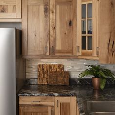 a kitchen with wooden cabinets and granite counter tops, including a dishwasher in the center