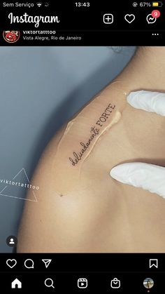 the back of a woman's breast with tattoos on her left side and words written in cursive writing