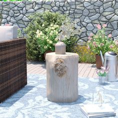 a wooden vase sitting on top of a table next to a flower pot filled with flowers