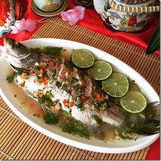 fish with limes and garnishes on a plate