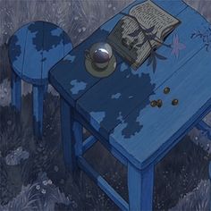 a blue table and chair with an open book on it