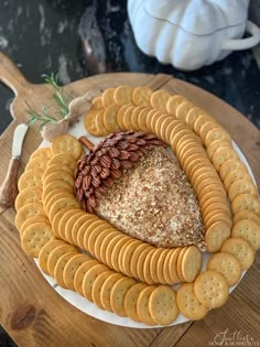 the best cheddar ranch cheese ball recipe on a white plate with crackers