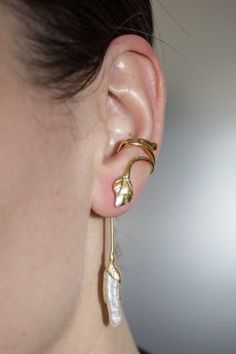 Luxury Crescent Earrings, Elegant Gold Brass Ear Cuff, Elegant Gold Leaf-shaped Jewelry, Unique Gold Pierced Ear Climbers, Gold Pearl Drop Cartilage Earrings As Gift, Adjustable Gold Plated Single Ear Cuff, Adjustable Single Gold Plated Ear Cuff, Elegant Gold Clip-on Ear Cuff, Elegant Handmade Adjustable Wrap Earrings