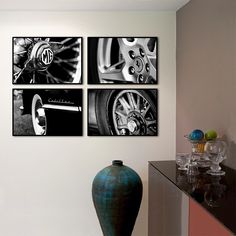 three black and white pictures hanging on the wall next to a vase with flowers in it