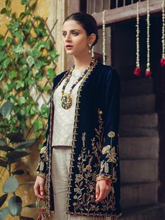 Pakistani Party Wear Organza Suits Online for Ladies is a contemporary Blue velvet jacket handcrafted using the finest techniques with gold enameled embroidery on the front and sleeves. It is paired with a screen-printed shirt and raw silk pants enhancing the details of the garment. Detailed Description: SKU: PN626 Detailing: Beads, Pearls, Embroidery, Sequins, Motifs Color: Blue Gold Fabric: Pure Silk Organza, Velvet Design: Fully Embellished Dress with Embroidery, Sequins, Motifs Event: Weddin Blue Velvet Jacket, Raw Silk Pants, Velvet Suit Design, Screen Printed Shirt, Organza Suits, Velvet Dress Designs, Pakistani Party Wear, Pakistani Fashion Party Wear, Indian Bridal Wear